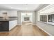 Open-concept kitchen with white cabinets, sleek countertops, and views of the outdoor living area at 6065 Merion Cir, Sanford, NC 27332
