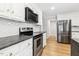 Chef's kitchen featuring stainless steel appliances, granite countertops, and white custom cabinetry at 6065 Merion Cir, Sanford, NC 27332