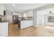 Modern kitchen featuring stainless steel appliances, a kitchen island and an open layout to the sunroom at 6065 Merion Cir, Sanford, NC 27332