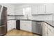 Updated kitchen with stainless steel appliances, granite countertops, and white cabinetry at 6065 Merion Cir, Sanford, NC 27332