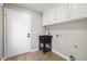 Bright laundry room with built-in cabinets, utility sink and door to the exterior at 6065 Merion Cir, Sanford, NC 27332
