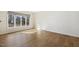 Bright room showcasing hardwood floors, a large window, and ample natural light at 6065 Merion Cir, Sanford, NC 27332
