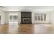 Spacious living area featuring a cozy fireplace, hardwood floors, and large windows at 6065 Merion Cir, Sanford, NC 27332