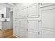 Floor to ceiling pantry with white cabinets and gold hardware at 6065 Merion Cir, Sanford, NC 27332