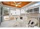 Relaxing screened-in porch with wicker furniture, wood ceiling, and tiled floor, perfect for outdoor living at 622 Sunset Ave, Apex, NC 27502