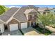 Overhead view of a two-story brick townhouse featuring a two-car garage and manicured lawn at 638 Village Lake Dr, Mebane, NC 27302