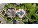Aerial view of a community pool area with lounge chairs, greenery, and a nearby clubhouse at 638 Village Lake Dr, Mebane, NC 27302