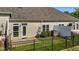 An image of a fenced backyard with a concrete patio and landscaped garden, perfect for outdoor relaxation at 638 Village Lake Dr, Mebane, NC 27302