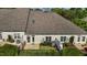 Aerial view of a townhouse with a small, fenced backyard featuring manicured landscaping and a patio area at 638 Village Lake Dr, Mebane, NC 27302