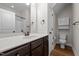Bright bathroom featuring a single sink vanity, framed mirror, and a toilet with a built-in shelf unit at 638 Village Lake Dr, Mebane, NC 27302