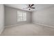 Bedroom with plush carpet, a ceiling fan, and a window with blinds for a comfortable and relaxing space at 638 Village Lake Dr, Mebane, NC 27302