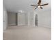 Large room with plush carpet, a ceiling fan, and two doors for ample natural light and movement at 638 Village Lake Dr, Mebane, NC 27302