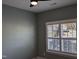 A bedroom with a ceiling fan and a shuttered window at 638 Village Lake Dr, Mebane, NC 27302