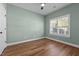 Cozy bedroom featuring a large window, wood floors and a ceiling fan at 638 Village Lake Dr, Mebane, NC 27302