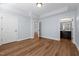 Bedroom with hardwood floors, blue walls, and an ensuite bathroom for additional convenience at 638 Village Lake Dr, Mebane, NC 27302