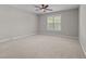 This room has a plush carpet and ceiling fan, and window with blinds for ample sunlight at 638 Village Lake Dr, Mebane, NC 27302