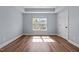 Empty bedroom with hardwood floors, a window with natural light, and a closet door at 638 Village Lake Dr, Mebane, NC 27302