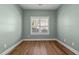 Bedroom featuring a large window, wood floors and neutral walls at 638 Village Lake Dr, Mebane, NC 27302