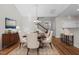 Well-lit dining room featuring hardwood floors, a chandelier, and a kitchen bar at 638 Village Lake Dr, Mebane, NC 27302