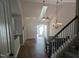 Bright dining room featuring hardwood floors, skylight, and a modern chandelier visible from staircase at 638 Village Lake Dr, Mebane, NC 27302