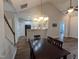 Dining room that opens to living room and kitchen featuring wood look flooring and a modern chandelier at 638 Village Lake Dr, Mebane, NC 27302