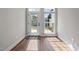 Bright entryway featuring hardwood floors, a glass door, and a window with exterior views at 638 Village Lake Dr, Mebane, NC 27302