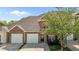 Inviting brick townhouse featuring a two-car garage, manicured lawn and easy access to the front door at 638 Village Lake Dr, Mebane, NC 27302