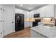 Modern kitchen with white cabinetry, granite countertops, stainless steel appliances, and wood flooring at 638 Village Lake Dr, Mebane, NC 27302