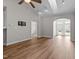 Open living area with high ceilings, wood flooring, recessed lighting, and access to a hallway and entryway at 638 Village Lake Dr, Mebane, NC 27302