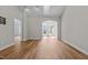 Open-concept living room with hardwood floors, recessed lighting, and arched doorway to the exterior at 638 Village Lake Dr, Mebane, NC 27302