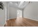 Bright and airy living room featuring hardwood floors and an arched doorway to the exterior at 638 Village Lake Dr, Mebane, NC 27302