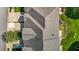 Aerial view of a house with an asphalt shingle roof, well-kept lawn, driveway, and a car parked on the side at 638 Village Lake Dr, Mebane, NC 27302