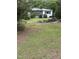 A quaint single story home with a screened in porch and an ample lawn and mature trees at 652 Old Sanford Rd, Moncure, NC 27559