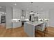 Modern white kitchen featuring a large center island, stainless steel appliances, and hardwood floors at 809 Tower St, Raleigh, NC 27607