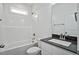 Bright bathroom featuring a shower and tub combination and vanity with dark countertop at 962 Spring Hill Church Rd, Lillington, NC 27546