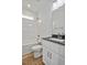 A well-lit bathroom showcases a shower and tub combination and a vanity with a dark countertop at 962 Spring Hill Church Rd, Lillington, NC 27546
