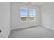 A carpeted bedroom has natural light from the windows at 962 Spring Hill Church Rd, Lillington, NC 27546
