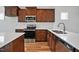 Spacious kitchen featuring stainless steel appliances, dark wood cabinets, and bright white countertops at 962 Spring Hill Church Rd, Lillington, NC 27546