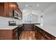 Beautiful kitchen with stainless steel appliances, dark cabinetry, light countertops, and wood-look flooring at 962 Spring Hill Church Rd, Lillington, NC 27546