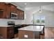 Well-lit kitchen featuring dark cabinets, stainless steel appliances, white subway tile backsplash, and quartz countertops at 962 Spring Hill Church Rd, Lillington, NC 27546