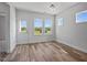 Sunlit living room featuring wood-look floors and large windows for ample natural light and outdoor views at 962 Spring Hill Church Rd, Lillington, NC 27546