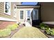 Landscaped backyard featuring well-manicured lawn, vibrant bushes, and an outdoor patio area at 1005 Whistler St, Durham, NC 27713