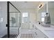 Elegant bathroom boasting double sinks, walk-in shower with black trim and a large window at 1005 Whistler St, Durham, NC 27713
