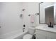 Clean bathroom with a tub, subway tile, matte black fixtures, and white vanity at 1005 Whistler St, Durham, NC 27713