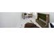 Bright room with a comfortable chair, rustic bookshelf and animal hide area rug at 1005 Whistler St, Durham, NC 27713