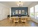 Elegant dining room featuring a large table with seating for six, a bold blue accent wall, and contemporary decor at 1005 Whistler St, Durham, NC 27713