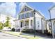 Stylish two-story home featuring a welcoming front porch, attractive siding, and well-maintained landscaping at 1005 Whistler St, Durham, NC 27713