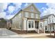Inviting two-story home with a covered porch, white trim, and a neatly landscaped front yard, offering great curb appeal at 1005 Whistler St, Durham, NC 27713
