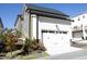 Exterior view of the garage with white siding and well-maintained landscaping at 1005 Whistler St, Durham, NC 27713