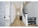 Bright hallway features wood floors, black banister on the staircase, and white doors at 1005 Whistler St, Durham, NC 27713